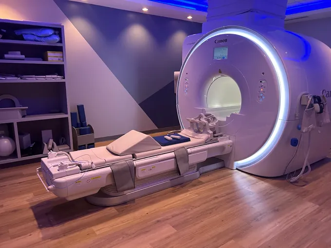 The wide-bore MRI scanner room with soft ambient lighting at Align Radiology