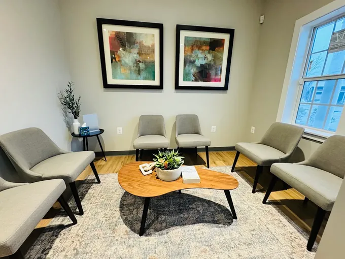 A quiet, sunlit waiting room with armchairs and artwork at Align Radiology